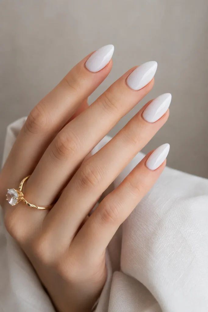 Glossy white almond nails with a smooth polished finish