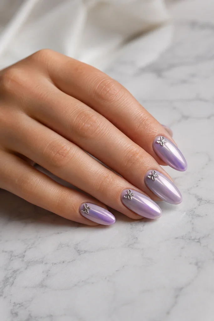 Lavender chrome nails with metallic butterfly accents