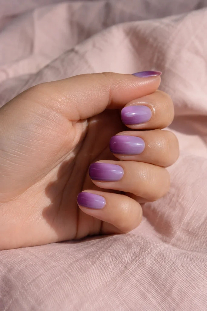 Lavender to plum ombre nails with glossy almond shape