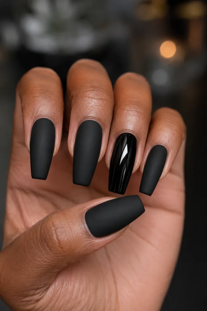 Matte black coffin nails with one glossy black accent nail.