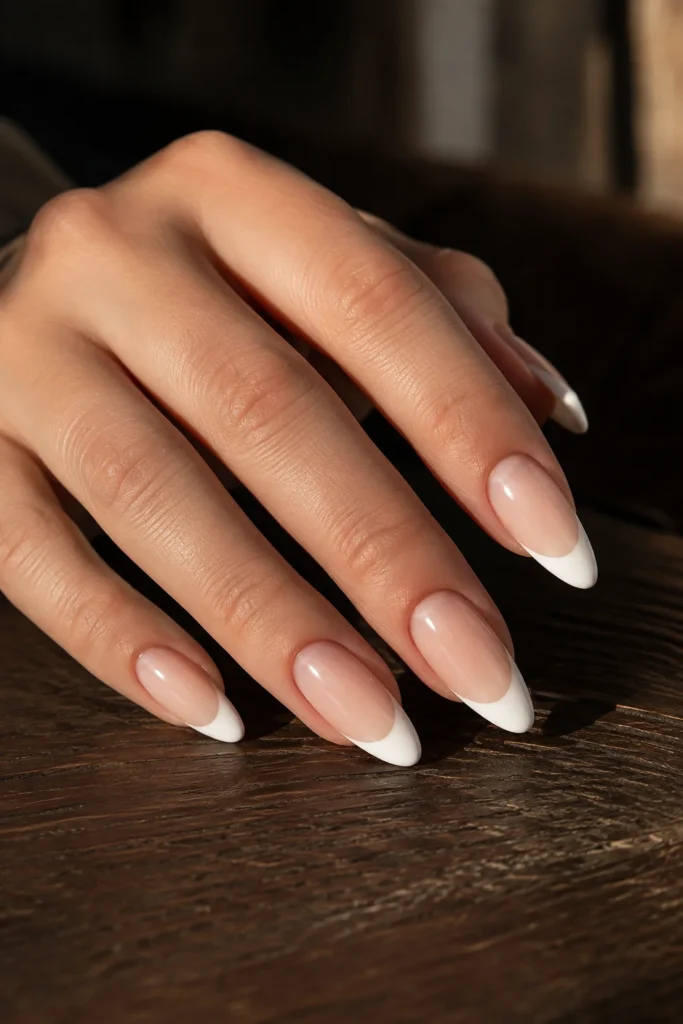 Matte white French tips over a glossy nude nail base