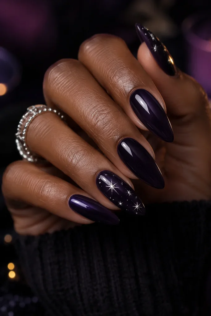Almond nails in midnight purple with silver star nail art