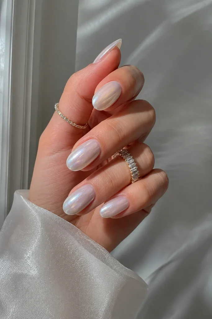 Pearl chrome milky white nails with a glossy iridescent finish