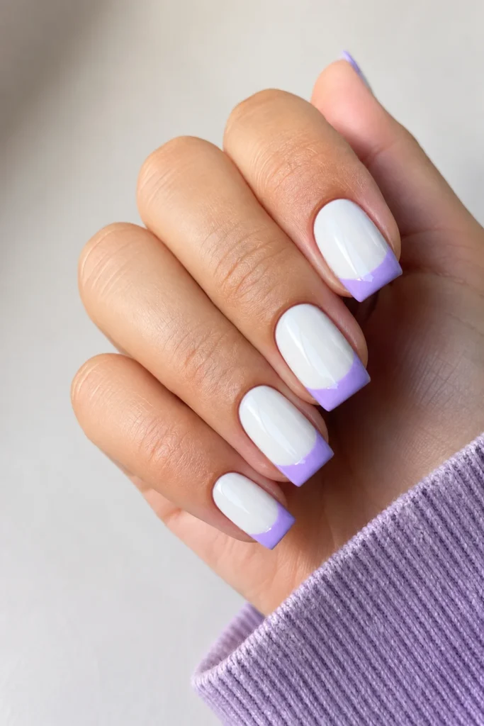 White base nails with soft pastel French tips in lavender and blue