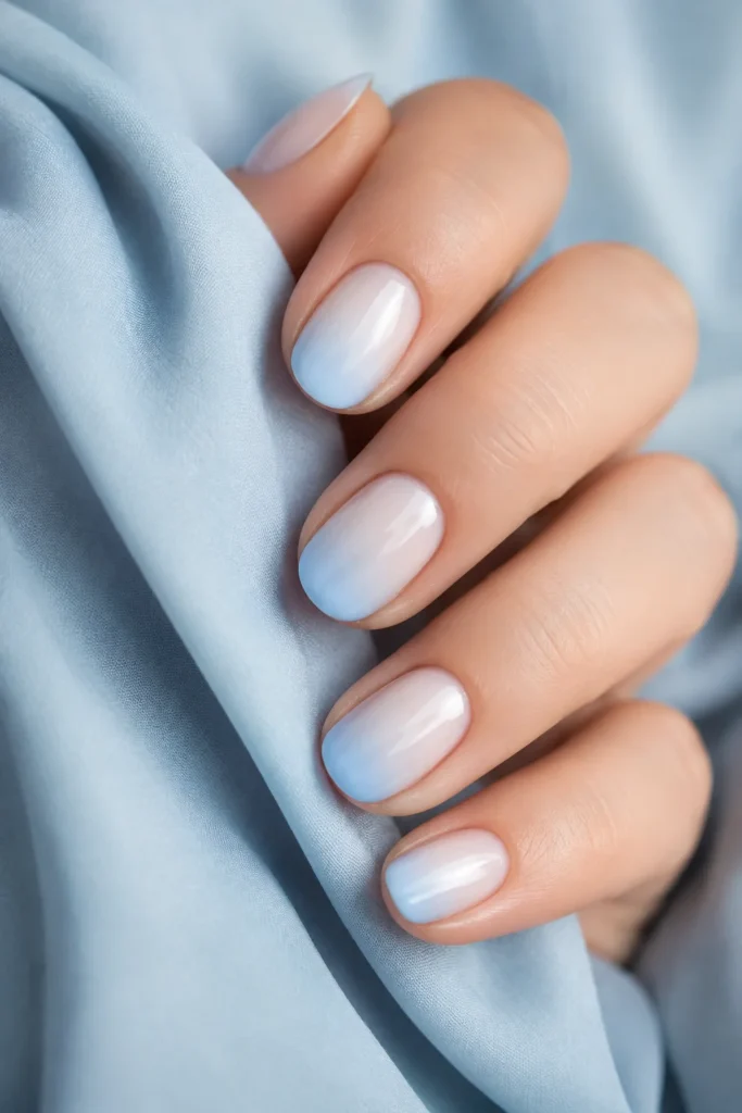 White nails fading into soft pastel ombre tips