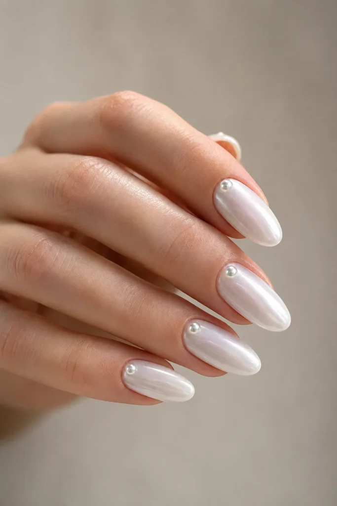White chrome almond nails with pearl dot details