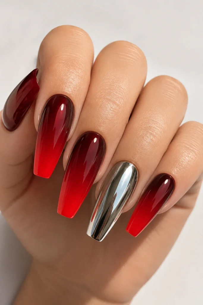 Red ombre nails with one chrome accent nail