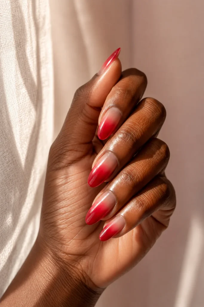 Red ombre nails fading into lighter tips