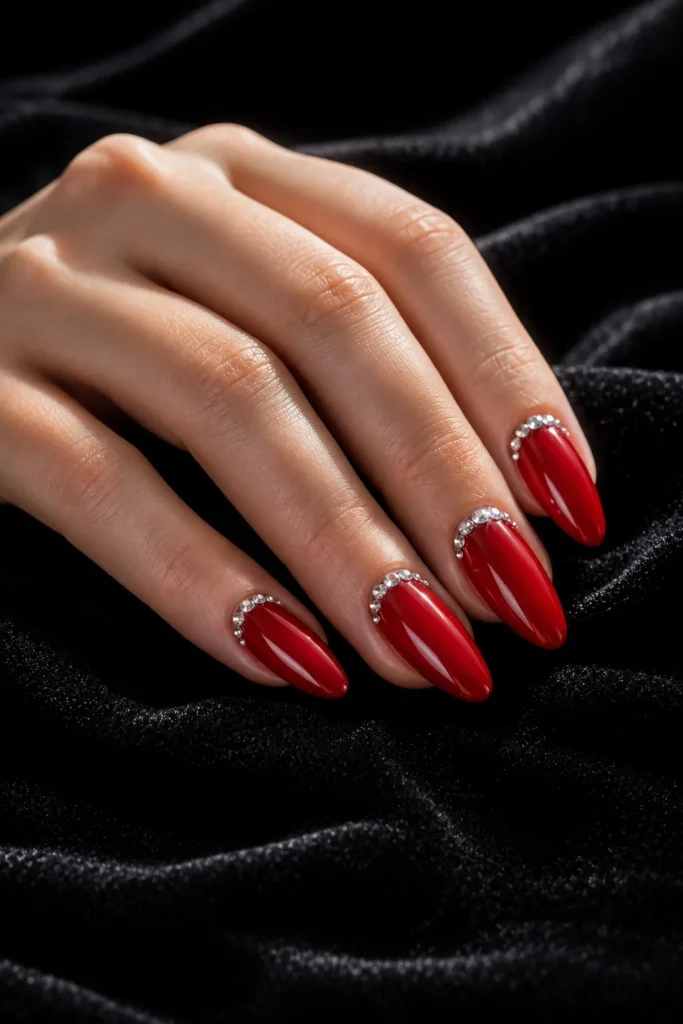 Red Valentine's nails with crystal rhinestone accents