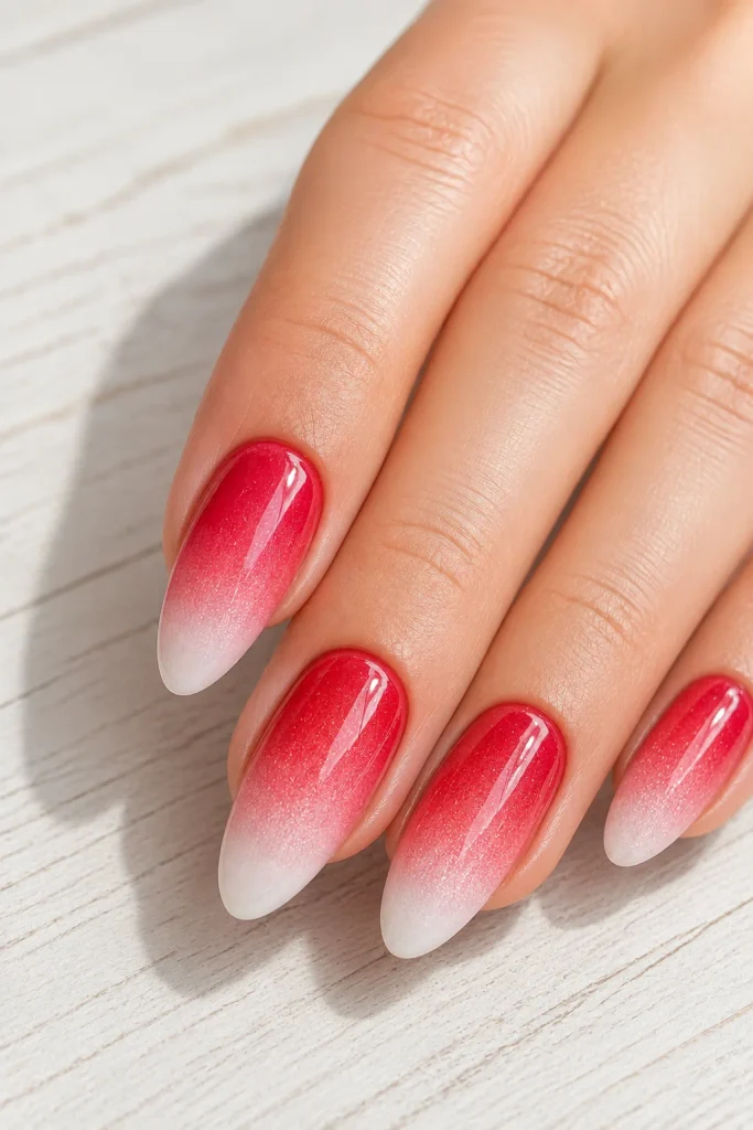 Soft red ombre nails fading into white