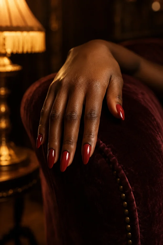 Ruby red almond-shaped nails for dark skin