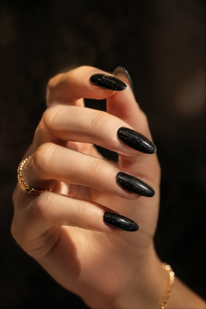 Shimmery black wedding nails with subtle sparkling finish