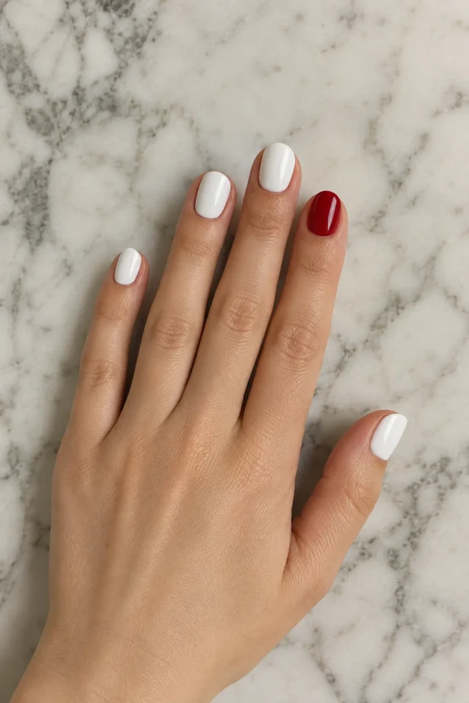 Short white nails with a colorful statement accent nail