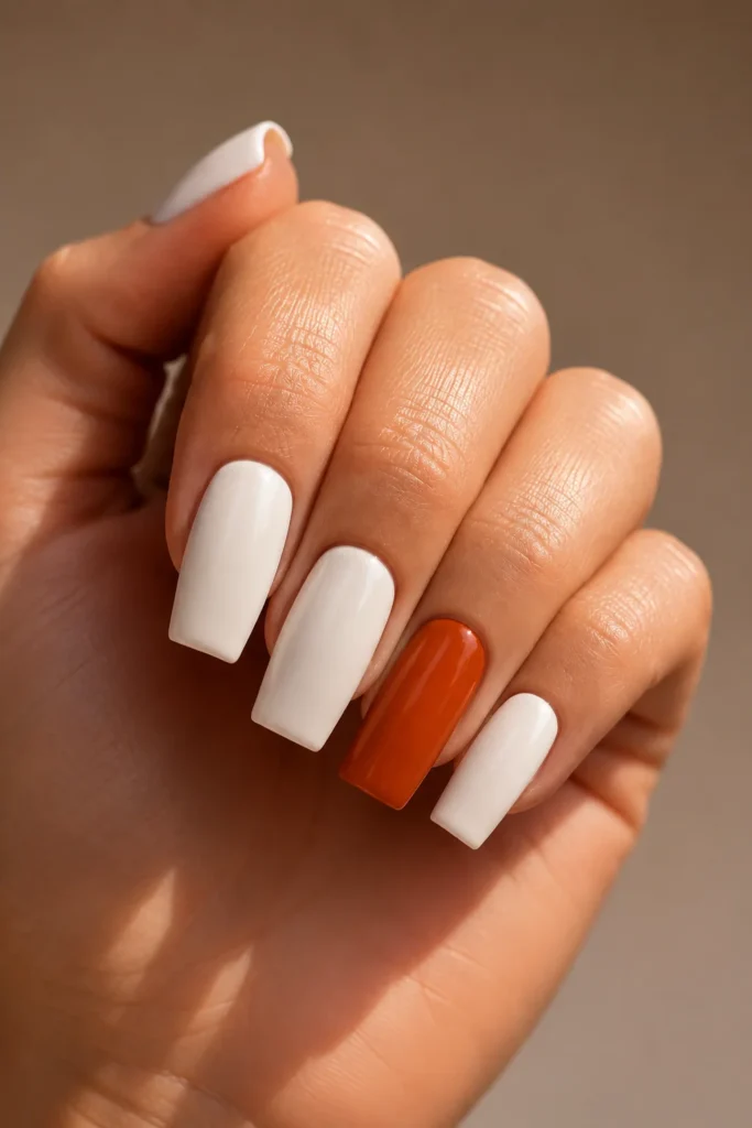 White fall nails with burnt orange accent nail on coffin shape