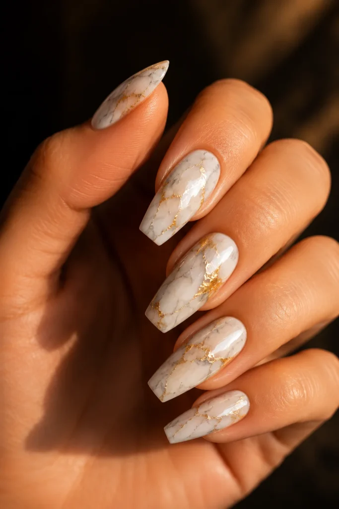 White marble nails with gold foil accents