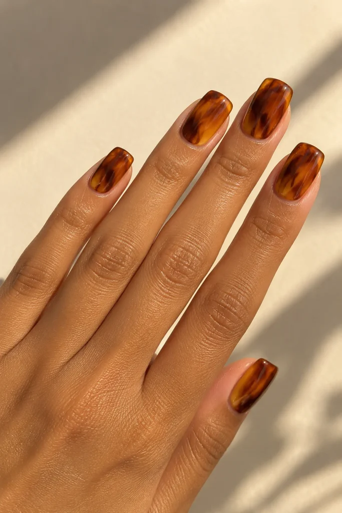 Amber jelly tortoiseshell swirl nails with layered brown details