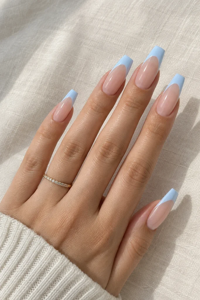 Baby blue French tips on medium coffin-shaped nails