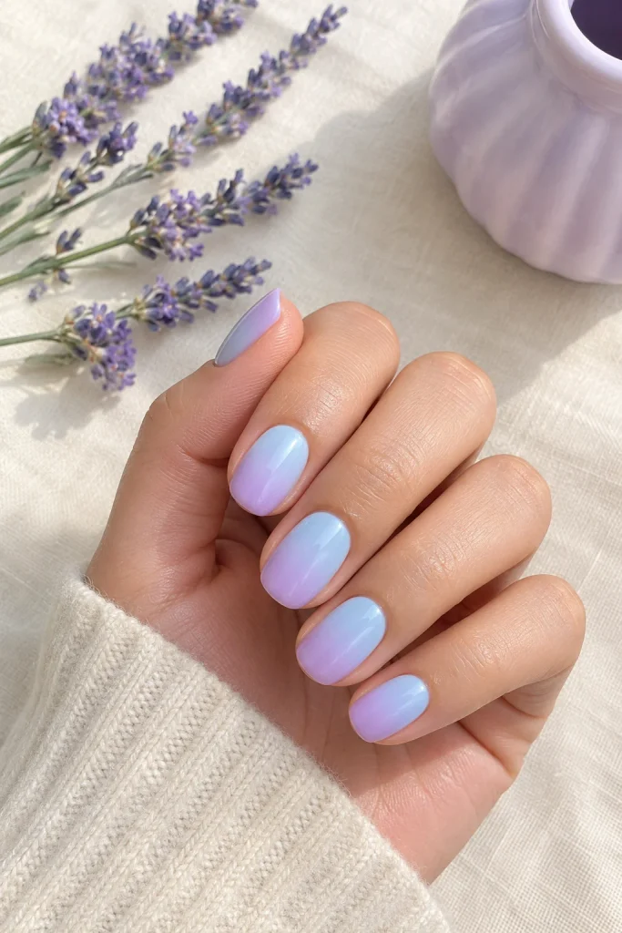 Pastel baby blue fading into lavender ombre nails