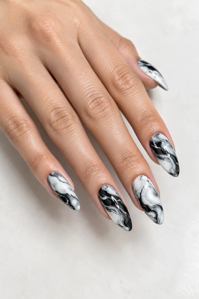 Black almond nails with white marble effect