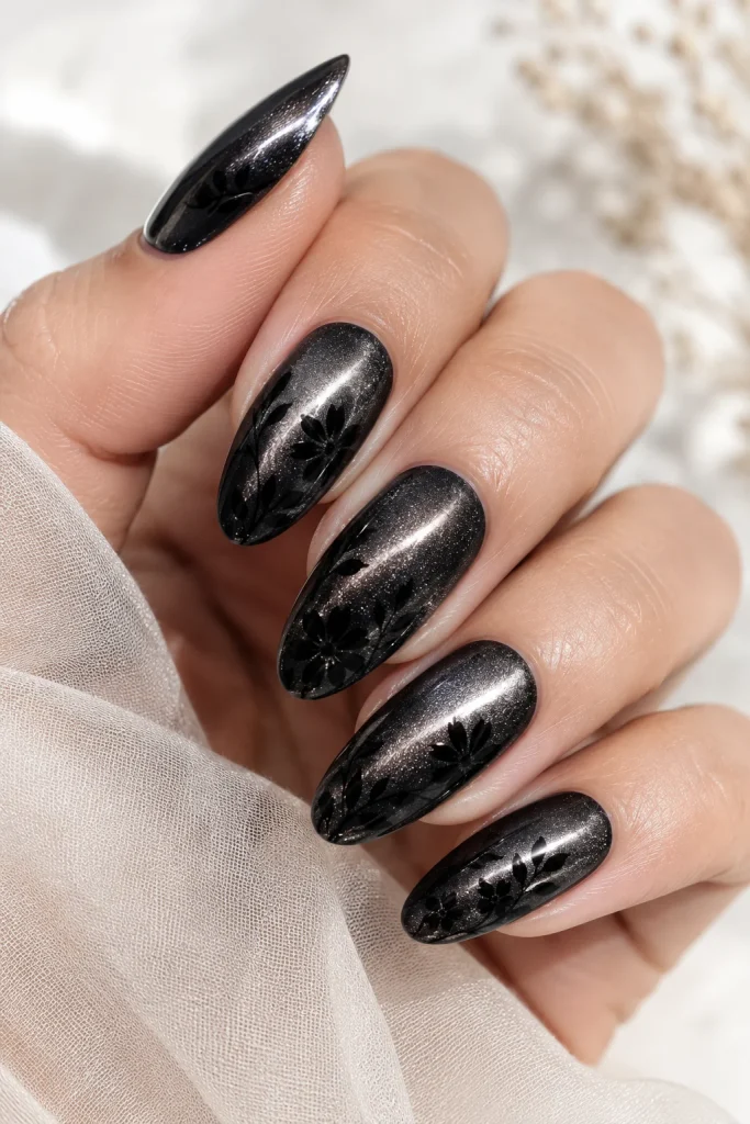 Black cat-eye nails with silhouette flower art
