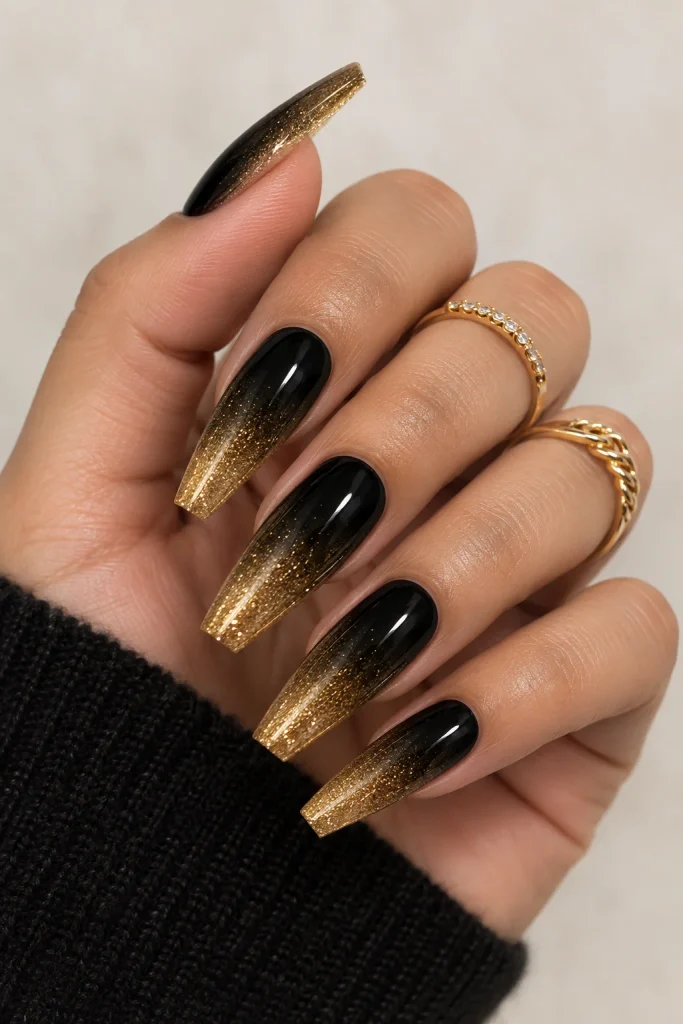 Black and gold shimmer ombre almond nails
