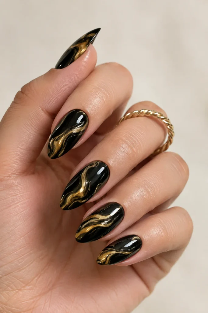 Deep black nails with golden yellow marble swirls