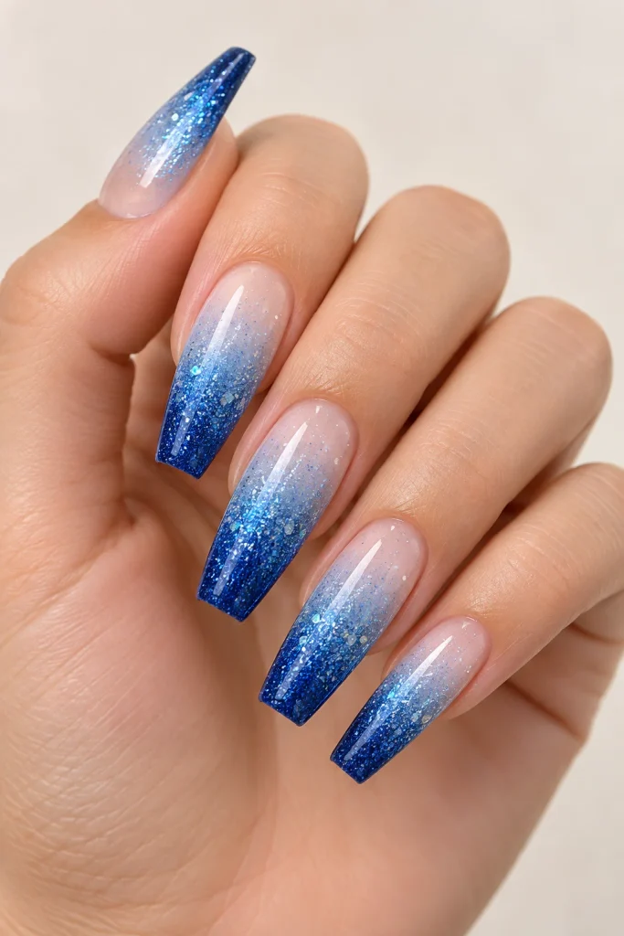Blue glitter ombre coffin nails blending light and dark shades