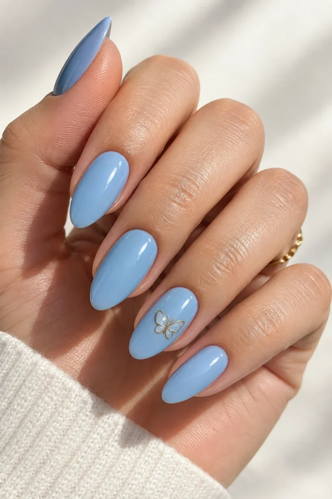 Blue nails with delicate gold butterfly nail art