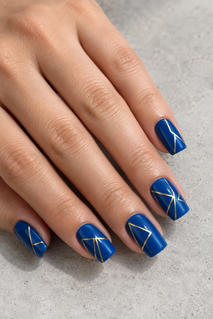 Blue nails featuring thin gold geometric line art