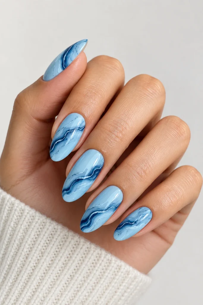Blue marble swirl nails with navy and white details