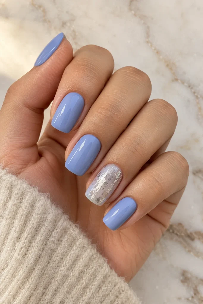 Soft blue nails with silver foil accent