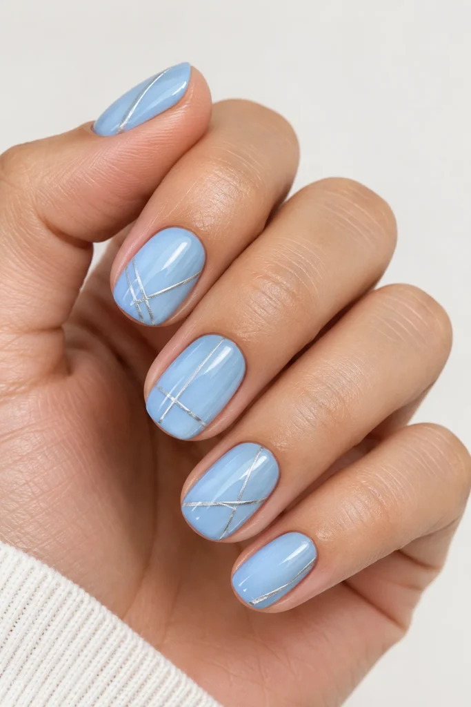 Blue nails with minimalist silver geometric line art