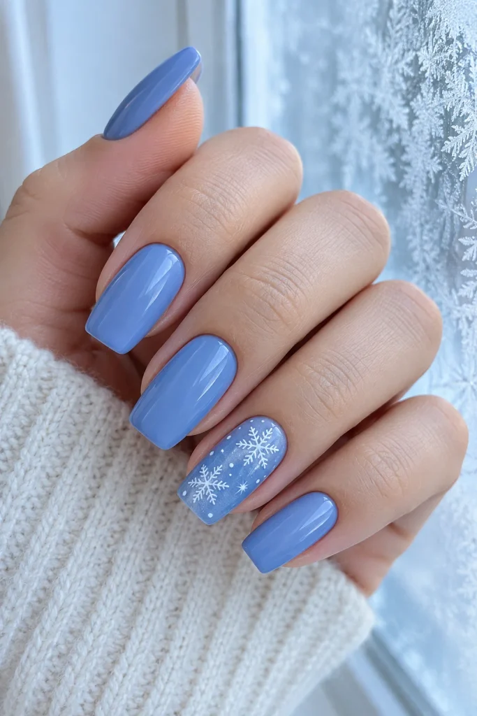Blue winter nails with white snowflake accent