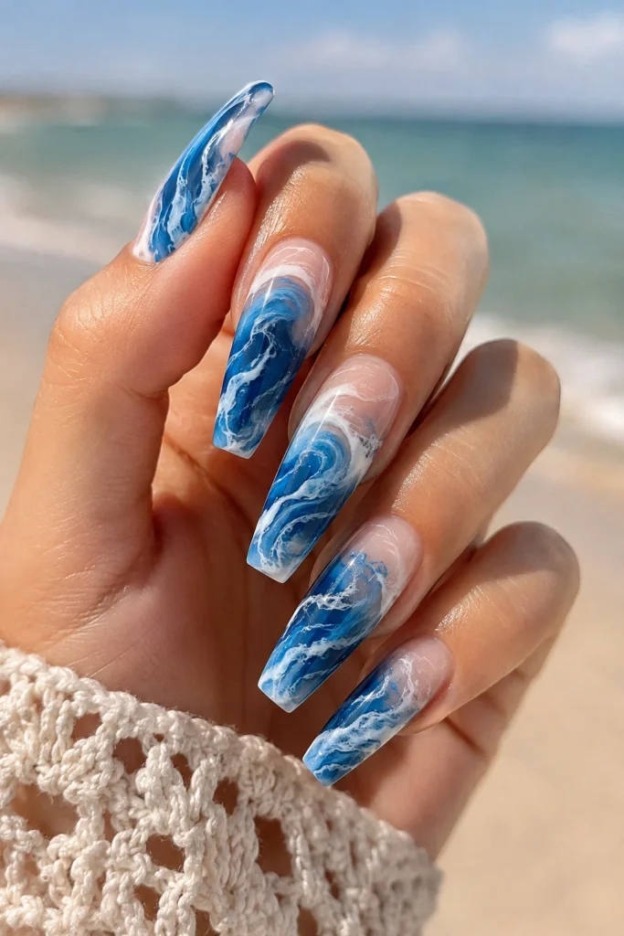 Blue and white ocean wave swirl nail design