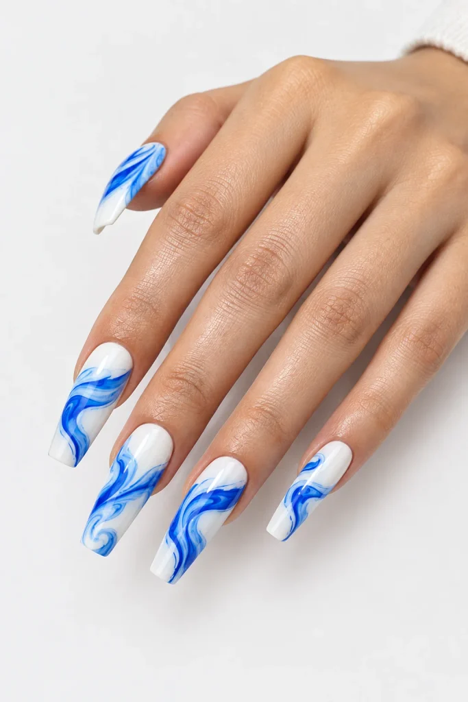 Soft blue and white ocean wave swirl nail design