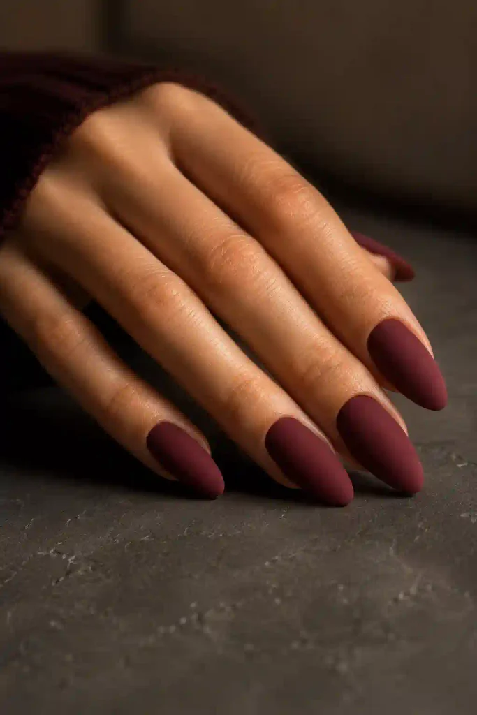 Long almond nails featuring deep burgundy wine matte polish