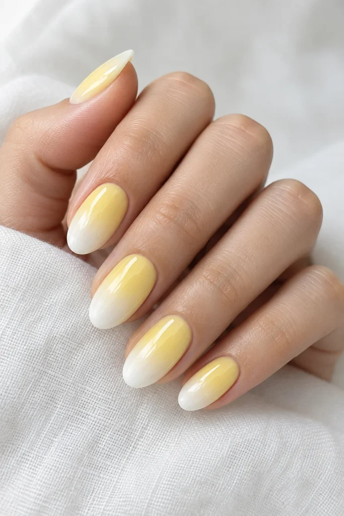 Butter yellow to white ombre nails with glossy finish