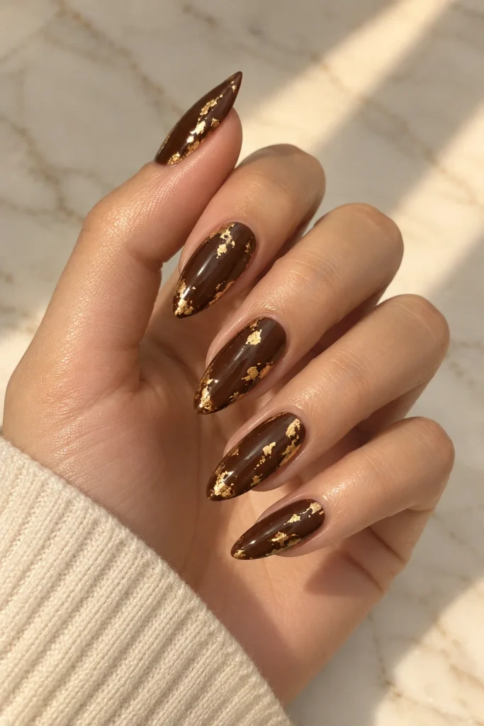 Chocolate brown nails with delicate gold foil accents