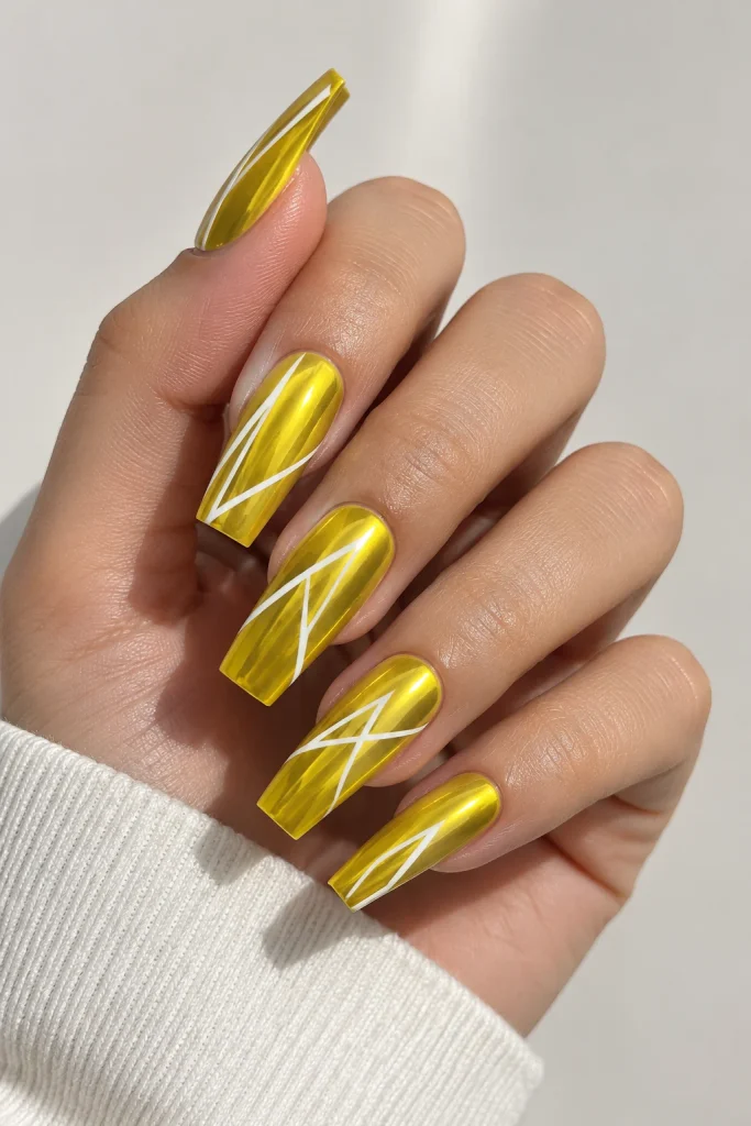 Chrome yellow nails with thin white geometric lines