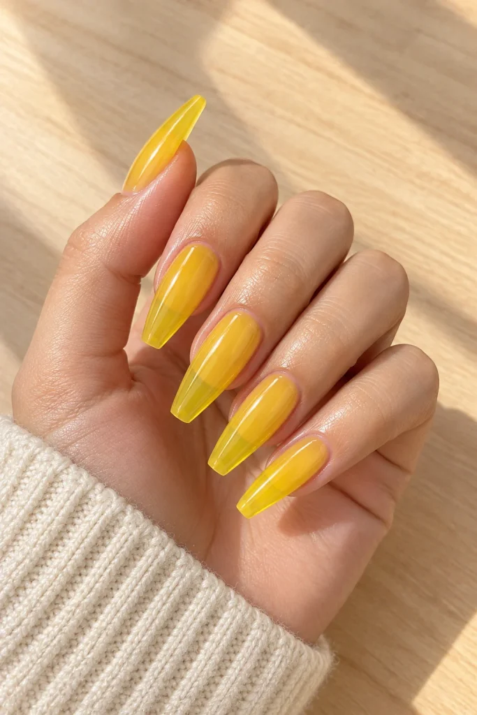 Citrus yellow jelly coffin nails with a sheer glossy finish