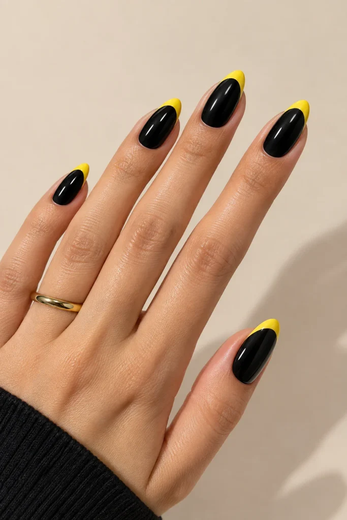 Black nails with bright yellow French tips