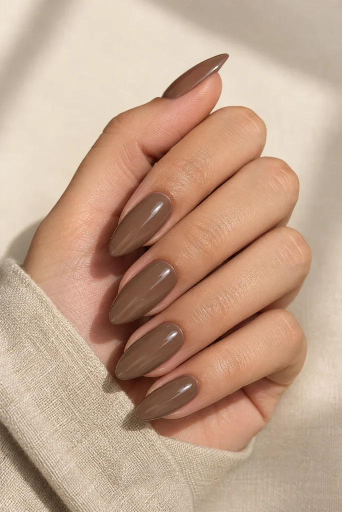 Glossy mocha brown almond nails with a smooth finish