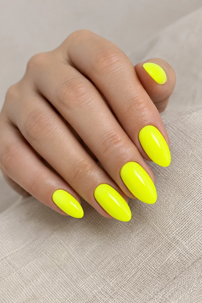 Classic glossy neon yellow nails on medium nails