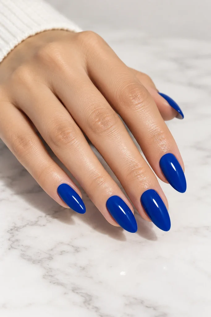 Classic glossy royal blue nails on medium almond shape