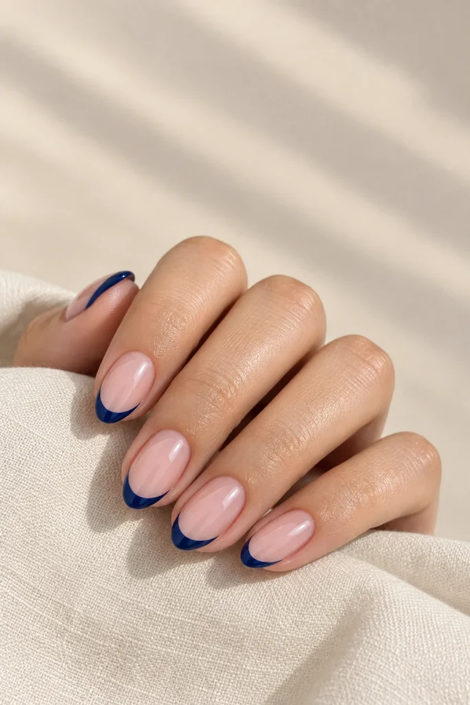 Classic navy blue French tips on sheer nude nails