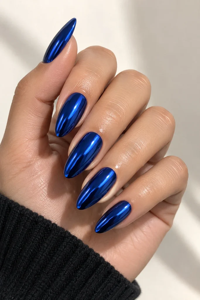 Deep blue nails with a reflective chrome finish