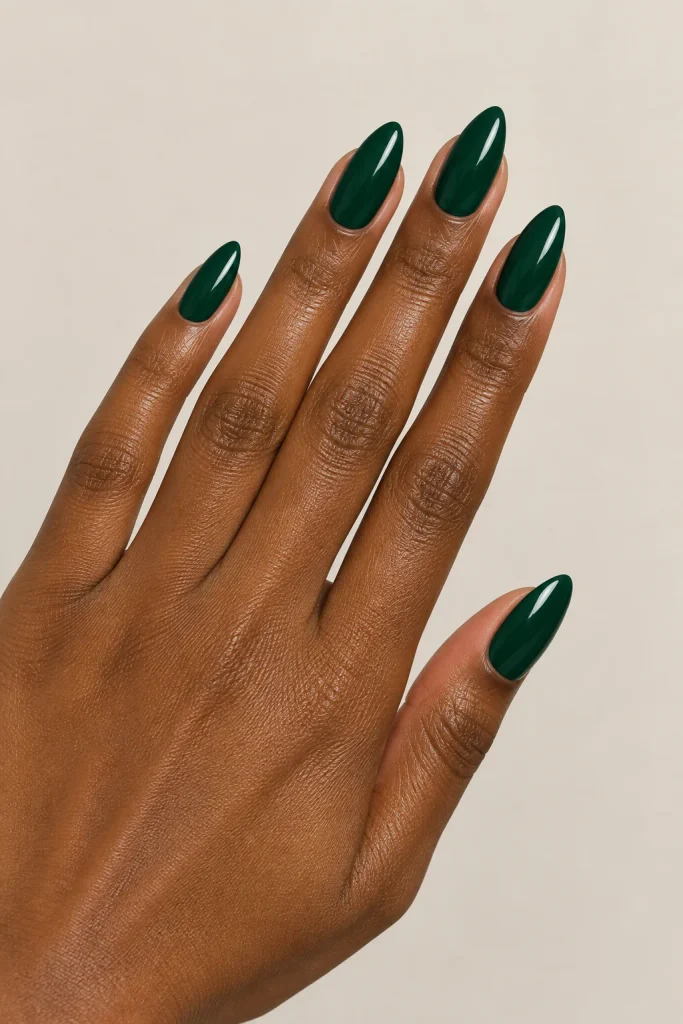 Deep emerald green nails on darker skin tone