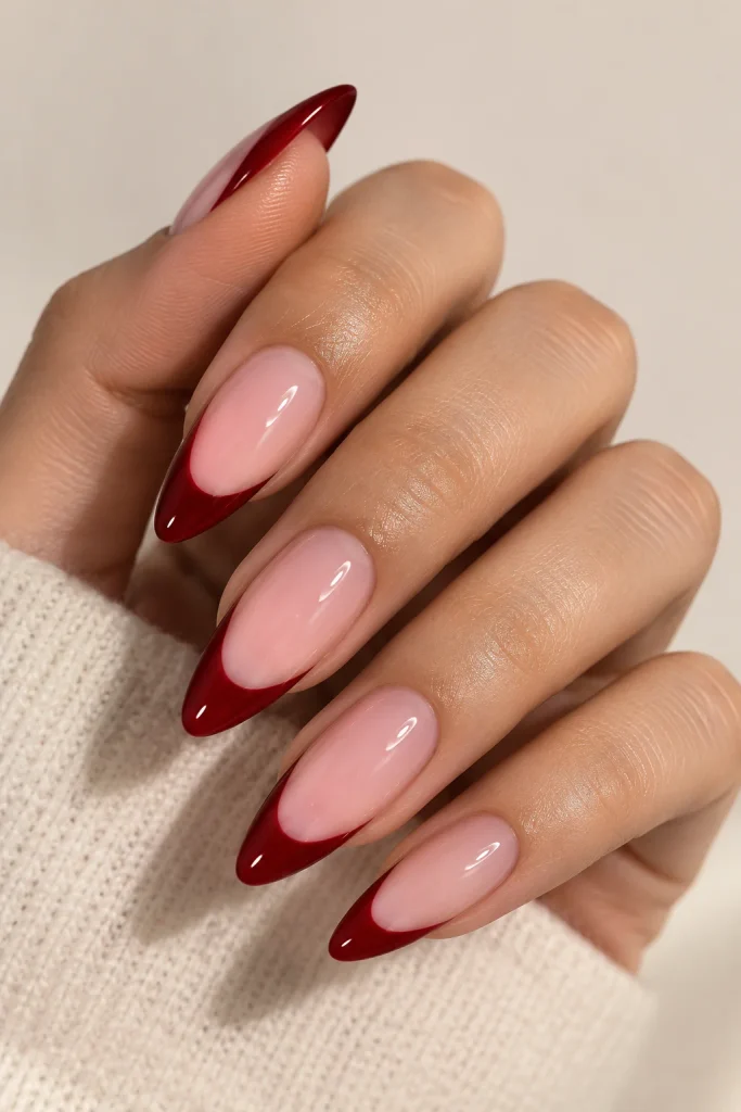 Deep red French tips on sheer pink nail base