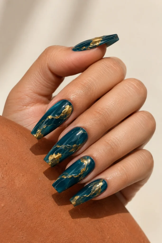 Deep teal blue nails with gold foil marble