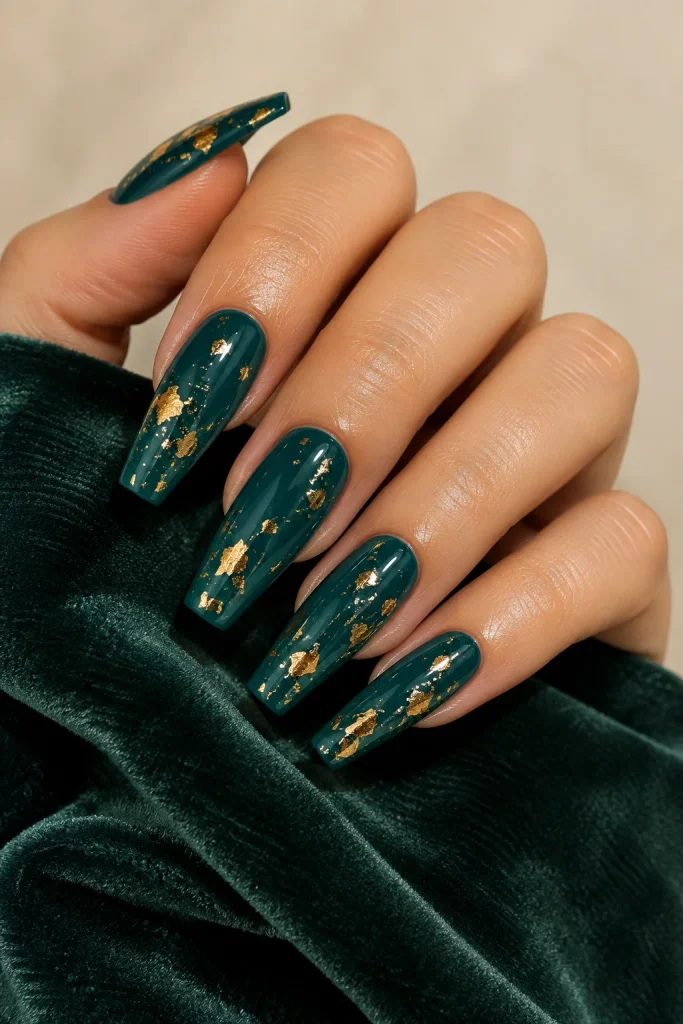 Deep teal coffin nails decorated with delicate gold foil
